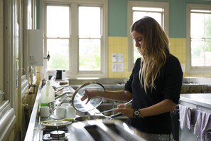 Guests can prepare meals in the fully equipped kitchen with a long counter and ample storage.