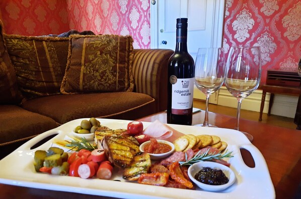 A dining table with a charcuterie board, wine bottle, and glasses. - The Abbey (Warwick)