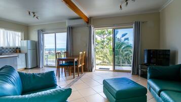 Standard Apartment, 2 Bedrooms, Oceanfront (upstairs) | Living area | Flat-screen TV, DVD player