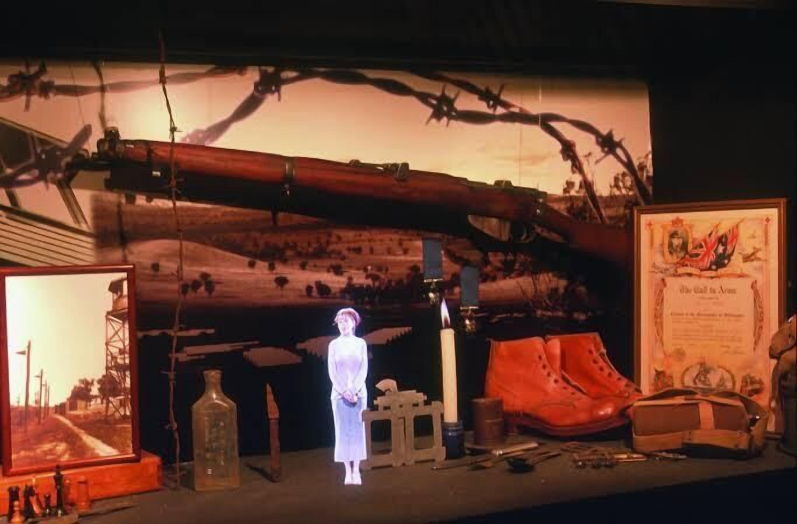 A display with a mannequin, a framed picture, a bottle, and a candle.