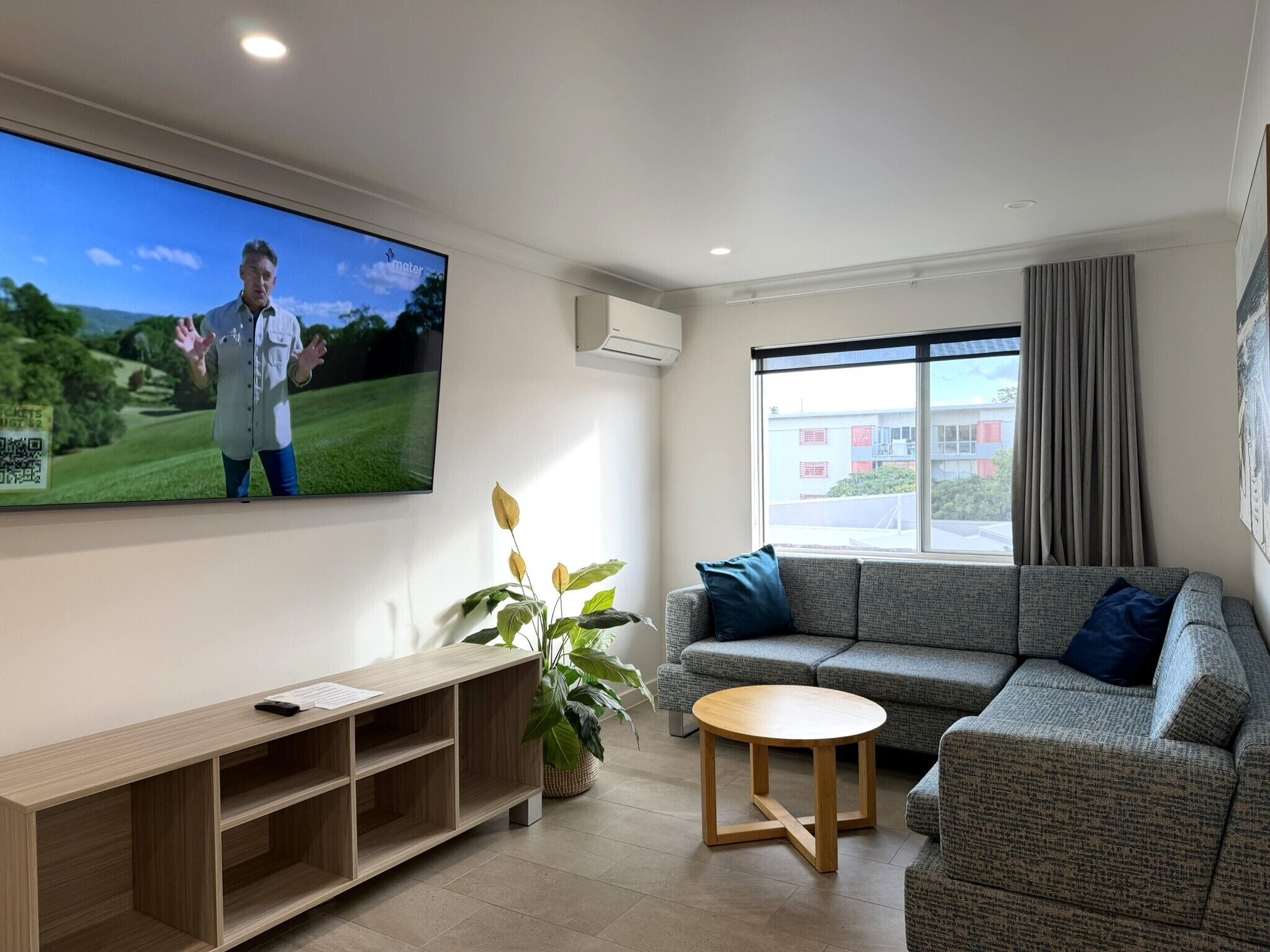 A living room with a TV, sofa, and a small table.