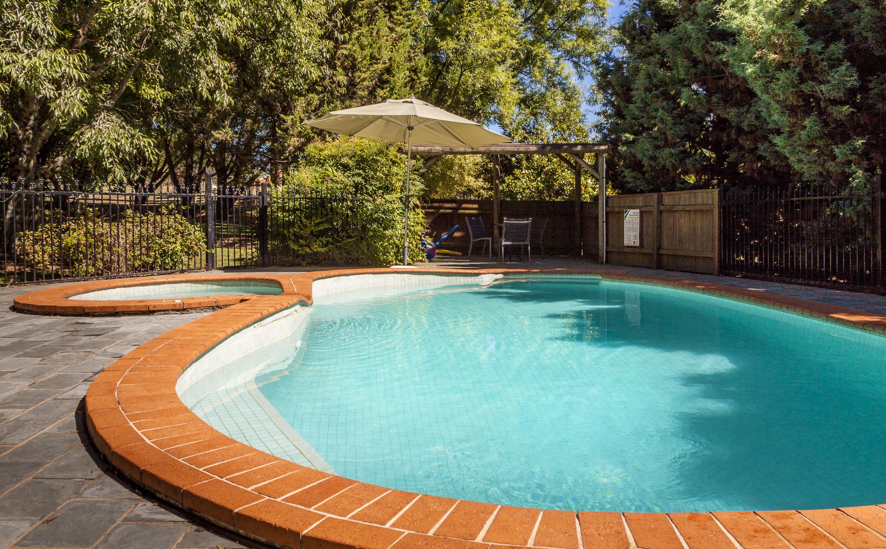 Outdoor pool, a heated pool, pool umbrellas, pool loungers