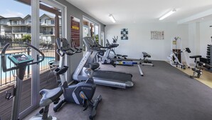 Een sportschool met loopbanden, hometrainers en krachttoestellen.