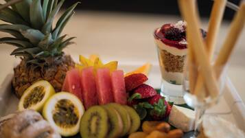 A fruit platter with various tropical fruits and a dessert.