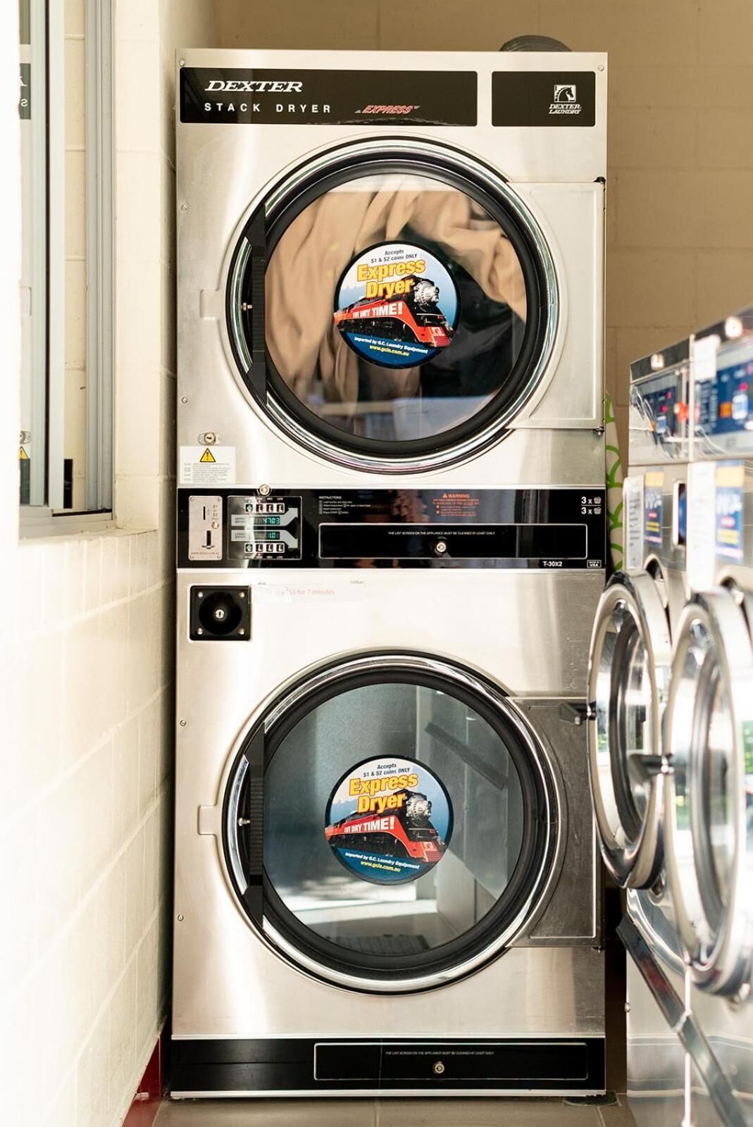 A stack dryer with a promotional sticker for the Express Dryer.
