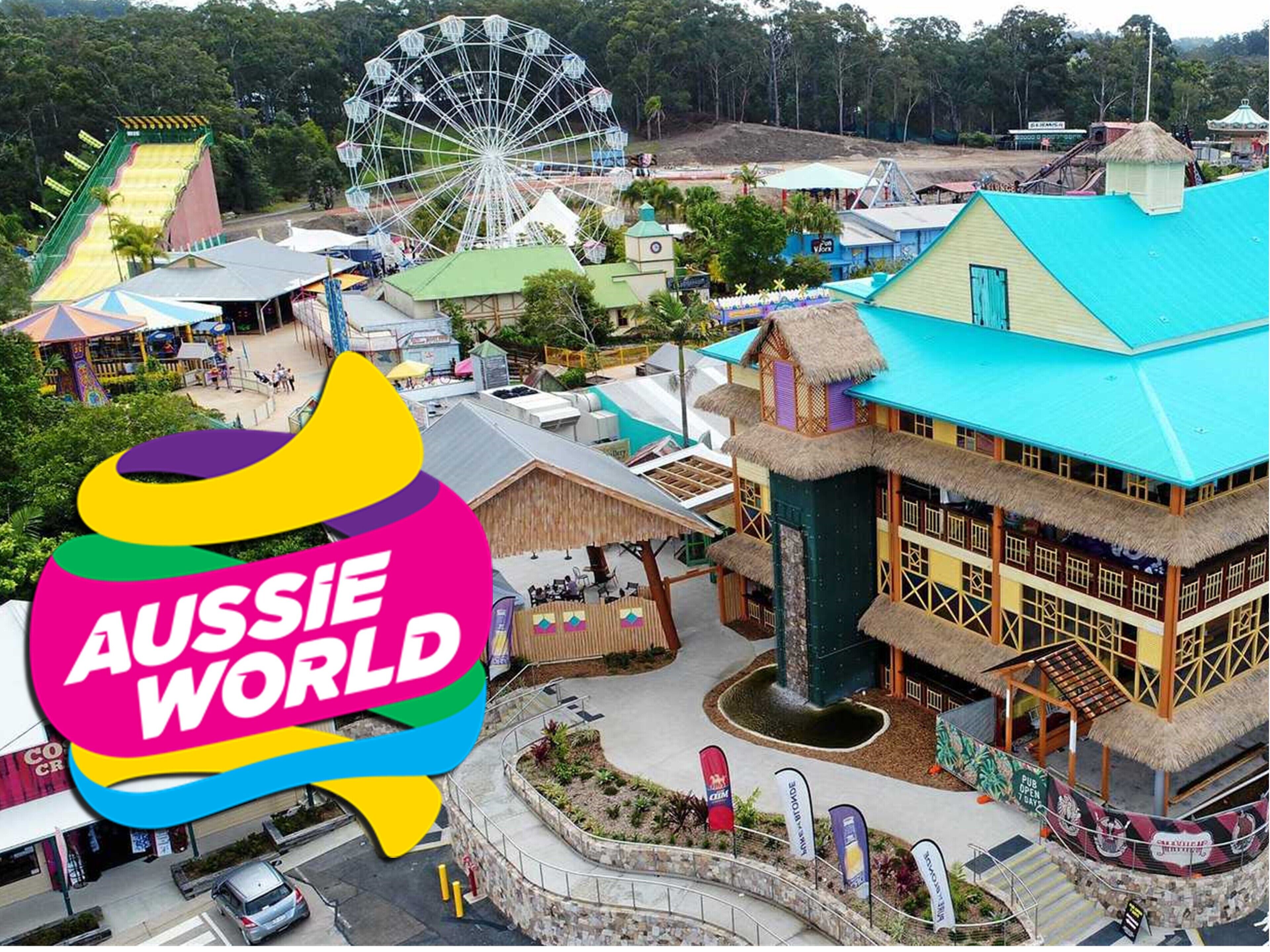 A colorful building with a thatched roof, a Ferris wheel, and a water slide in the background.