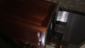A kitchen with wooden cabinets, a stainless steel sink, and a granite countertop. - Country Plaza Motor Inn (West Mackay)