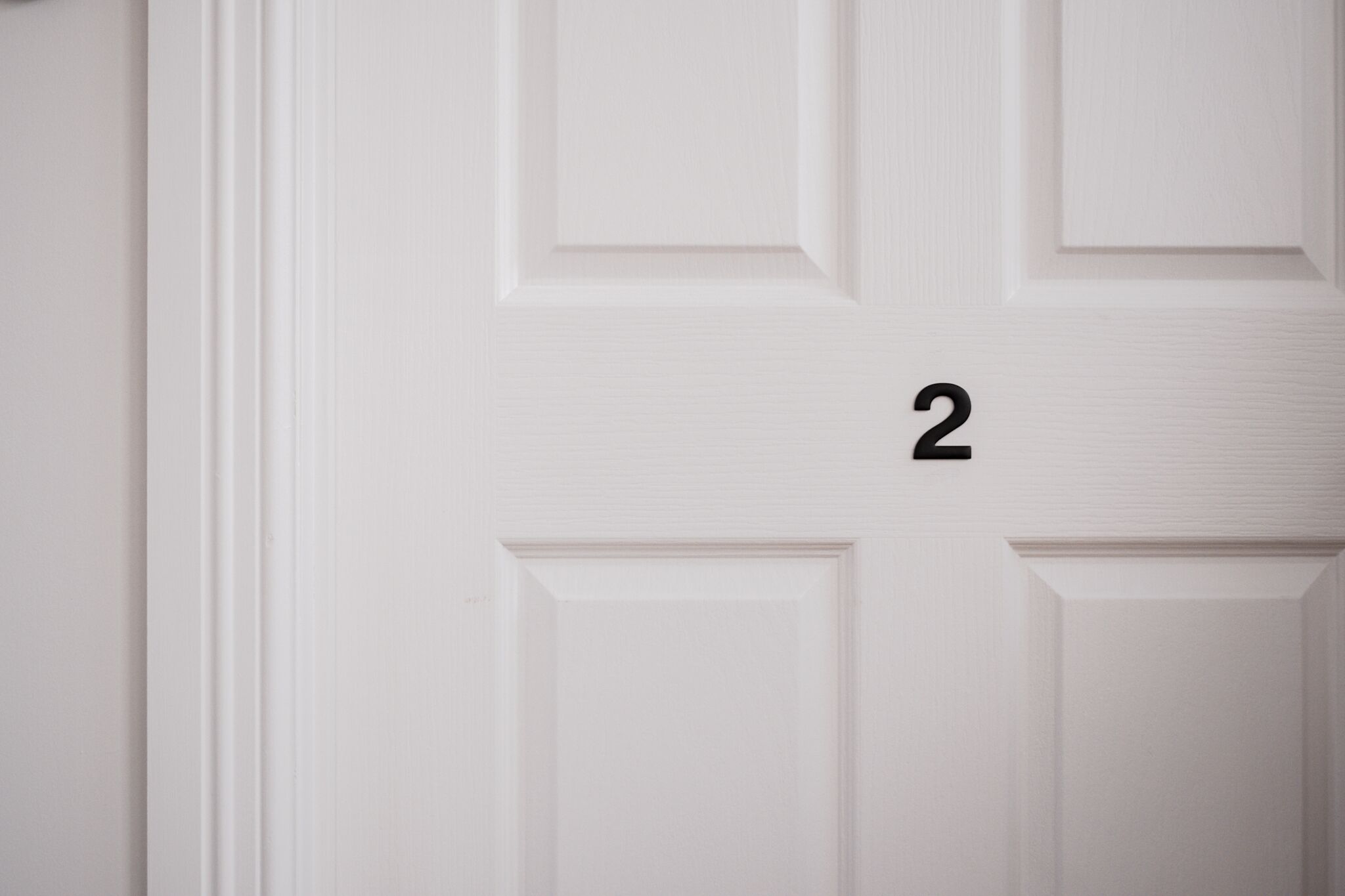A white door with a number "2" on it.