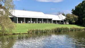 A modern building with a flat roof and covered outdoor seating area. - Briars Country Lodge (Burradoo)