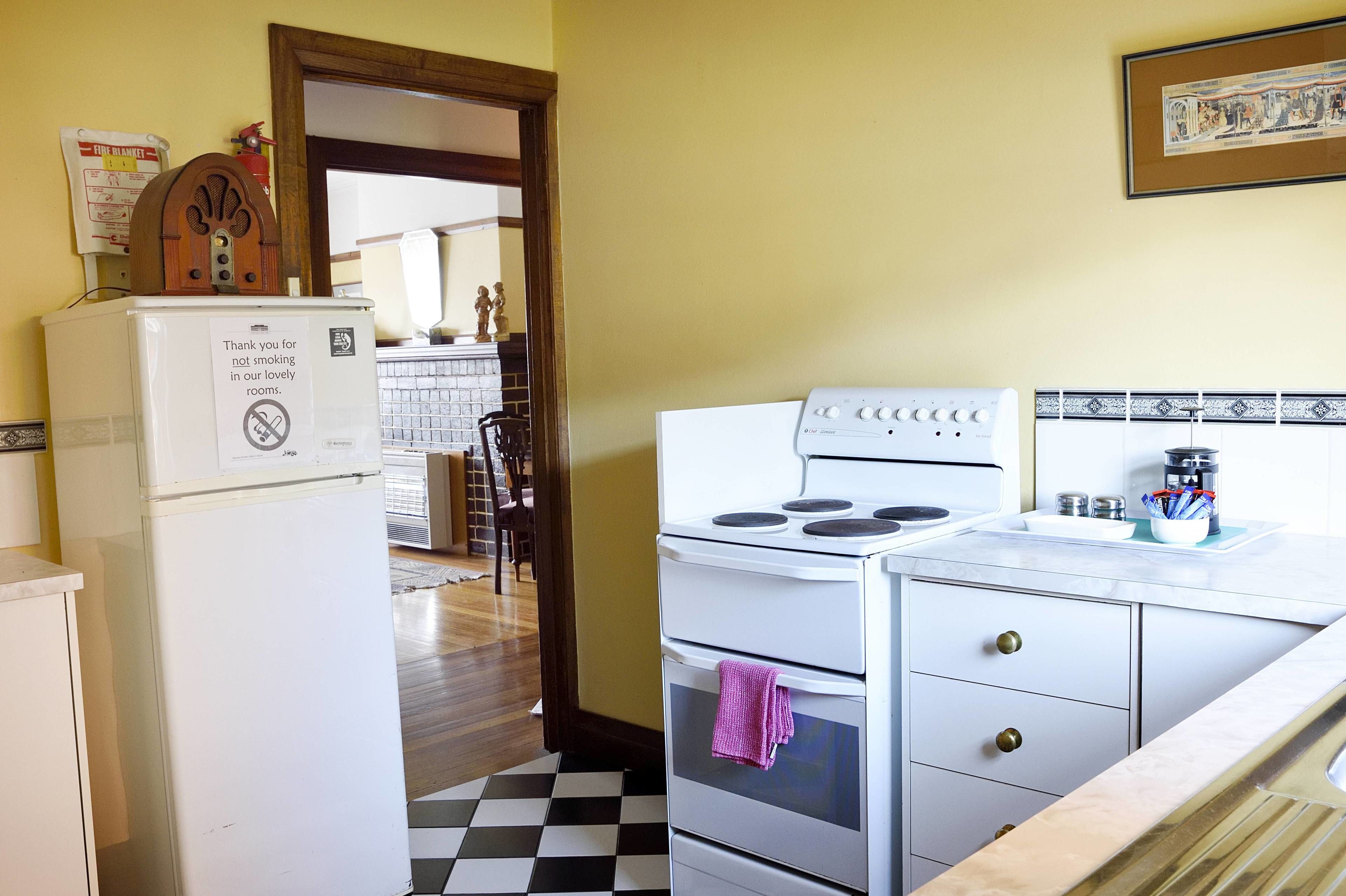 A kitchen with a refrigerator, stove, and a sink.