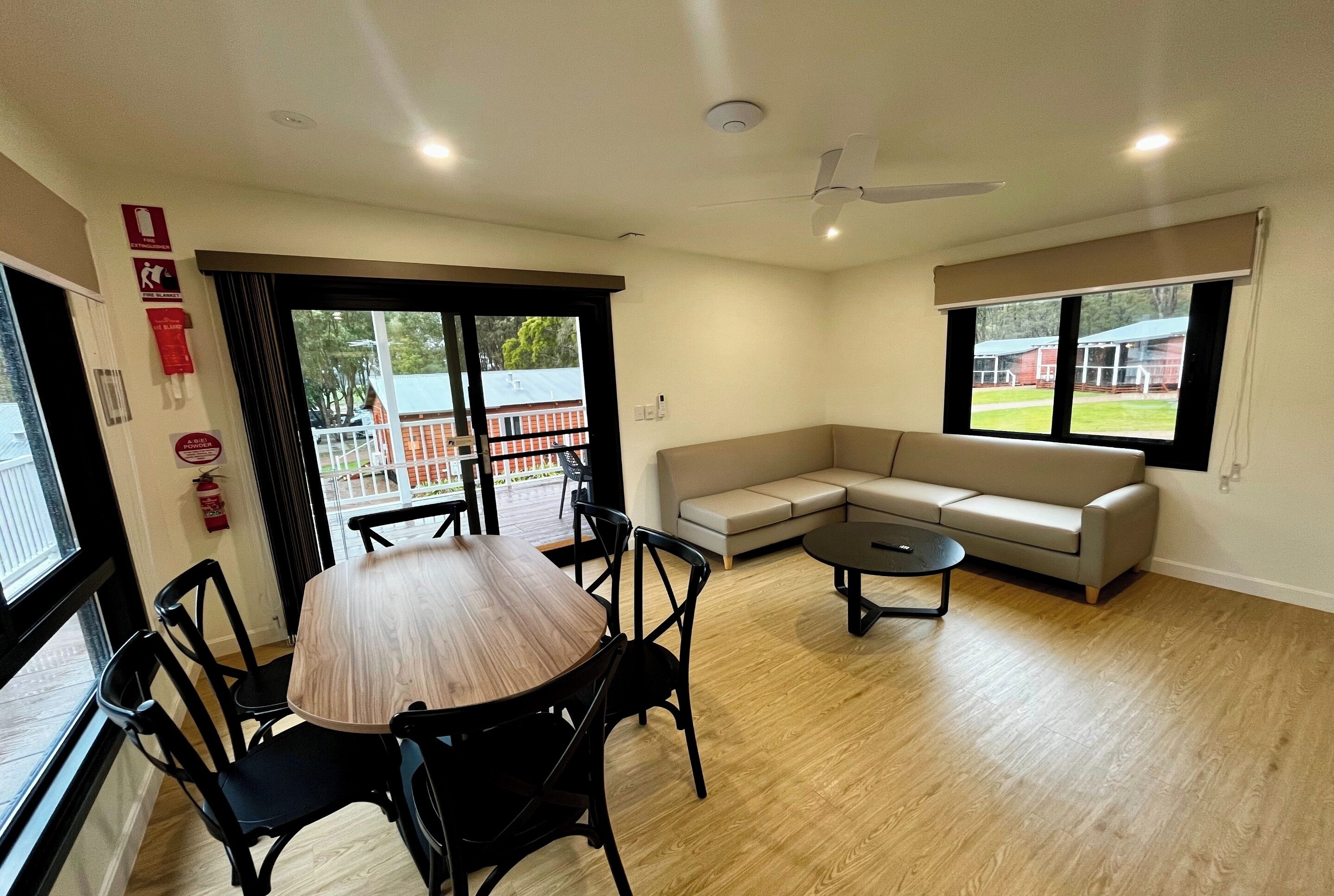 Deluxe 2 Bedroom Cabins - S6 | Living area | Flat-screen TV