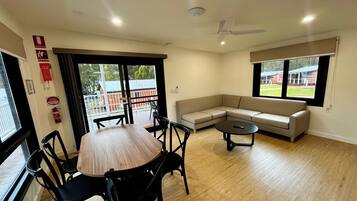 Deluxe 2 Bedroom Cabins - S6 | Living area | Flat-screen TV