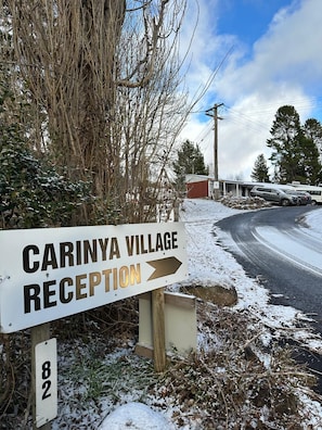 A sign for Carinya Village Reception with a directional arrow.