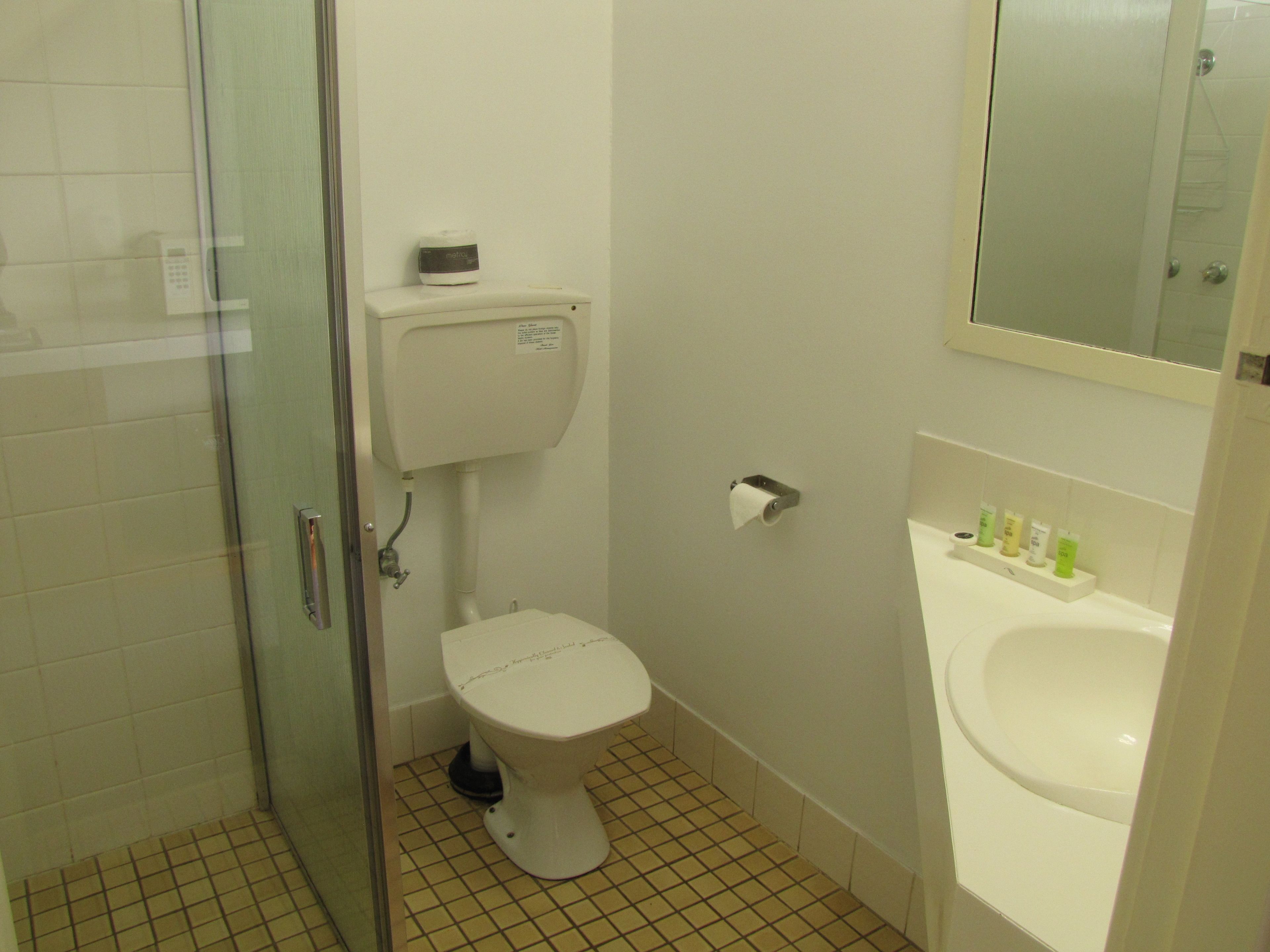 A bathroom with a toilet, a bidet, and a sink.