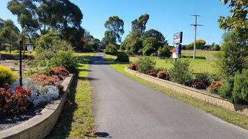 A road leading to a motel with a signboard.