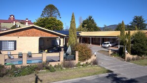 A residential property with a garage, a swimming pool, and a covered outdoor area. - Settlers Motor Inn (Tenterfield)