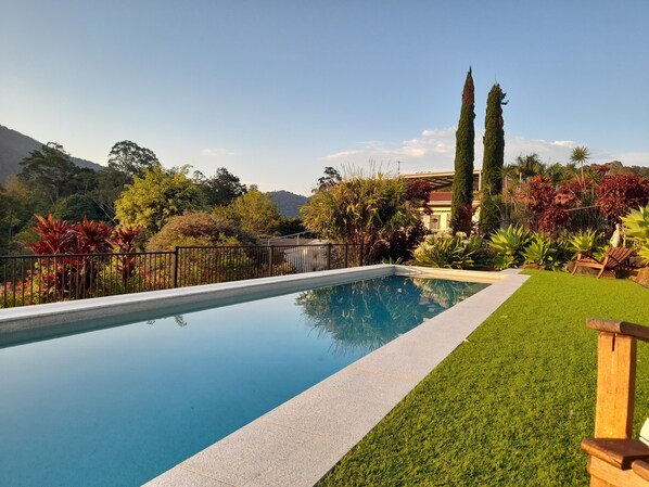 Outdoor pool, open 6:00 AM to 9:00 PM, pool umbrellas