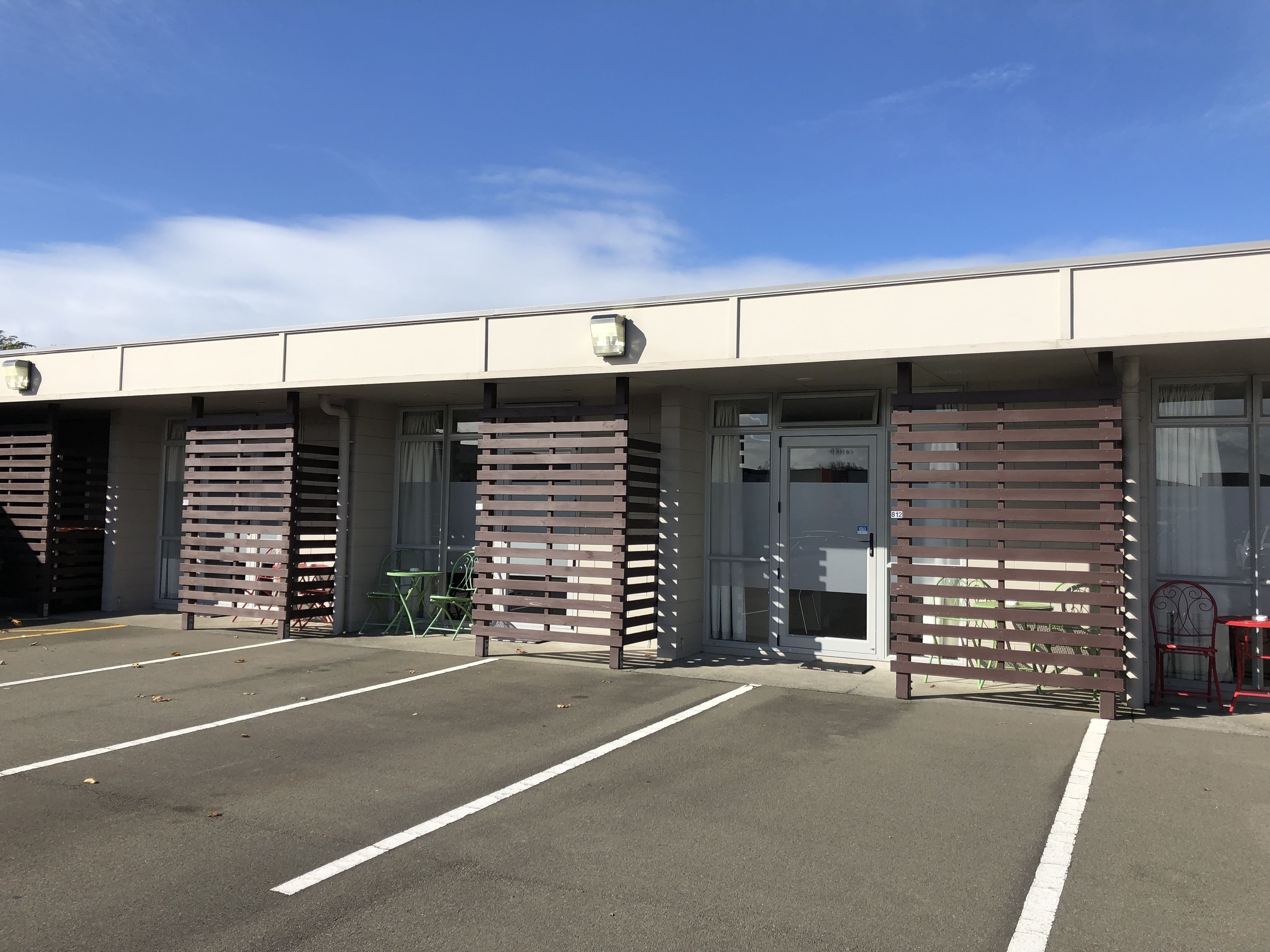 A building with a parking lot and a gated entrance.