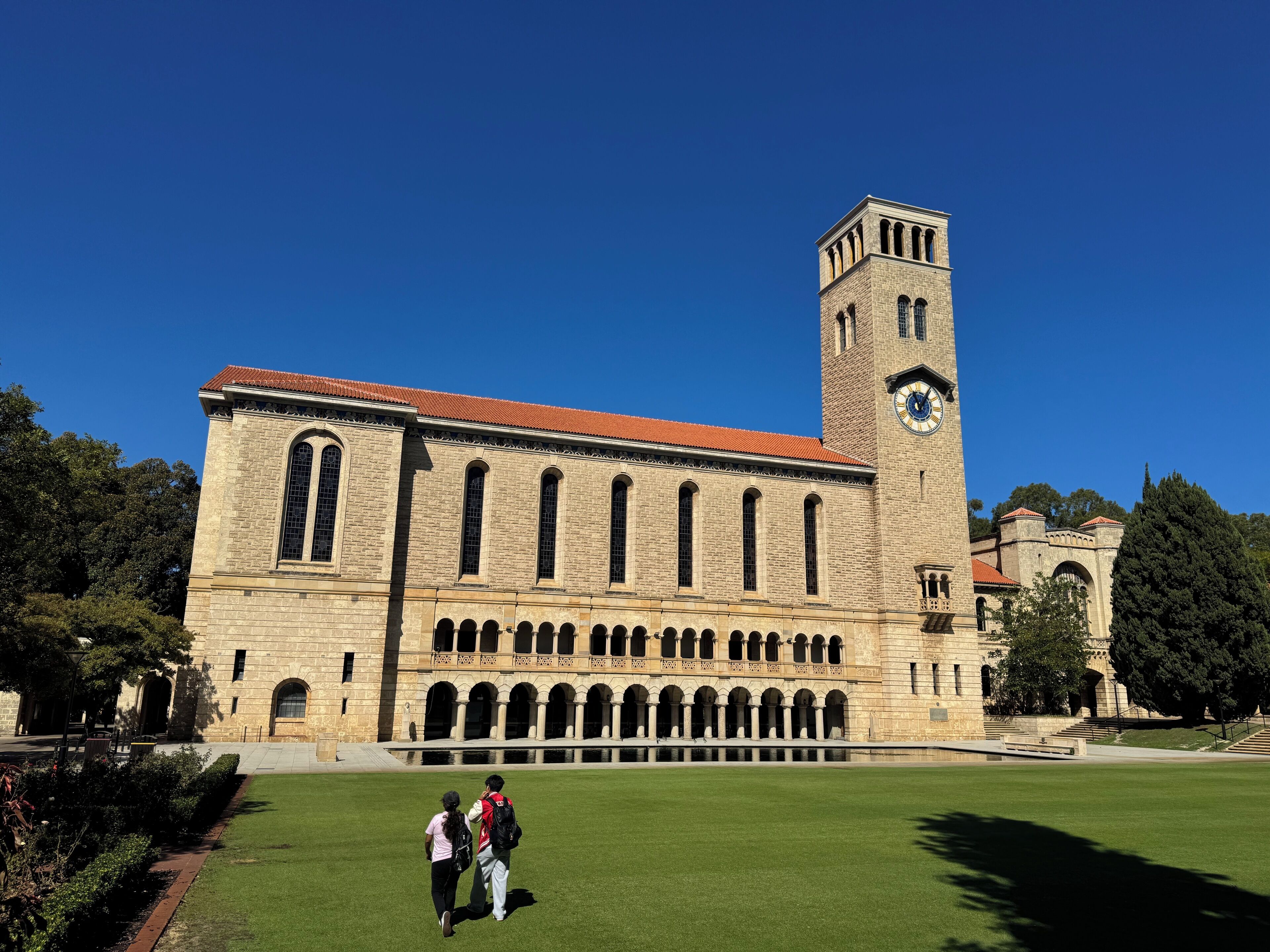 A large historic building with a prominent clock tower and arched windows.