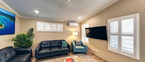 Premium Cottage, 2 Bedrooms, Garden Area | Living area | 55-inch TV with digital channels, DVD player