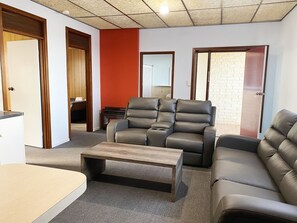 A living room with a sectional sofa, a recliner, and a coffee table.