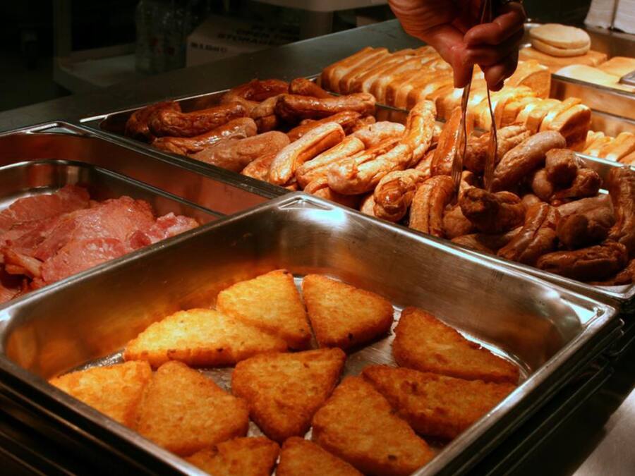 A buffet with various food items including fried items and pastries.