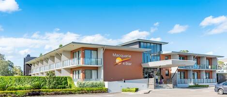 A modern hotel with a prominent sign reading "Macquarie 4 Star."