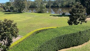 A park with a pond, green grass, and trees. - Macquarie 4 Star (Argenton)
