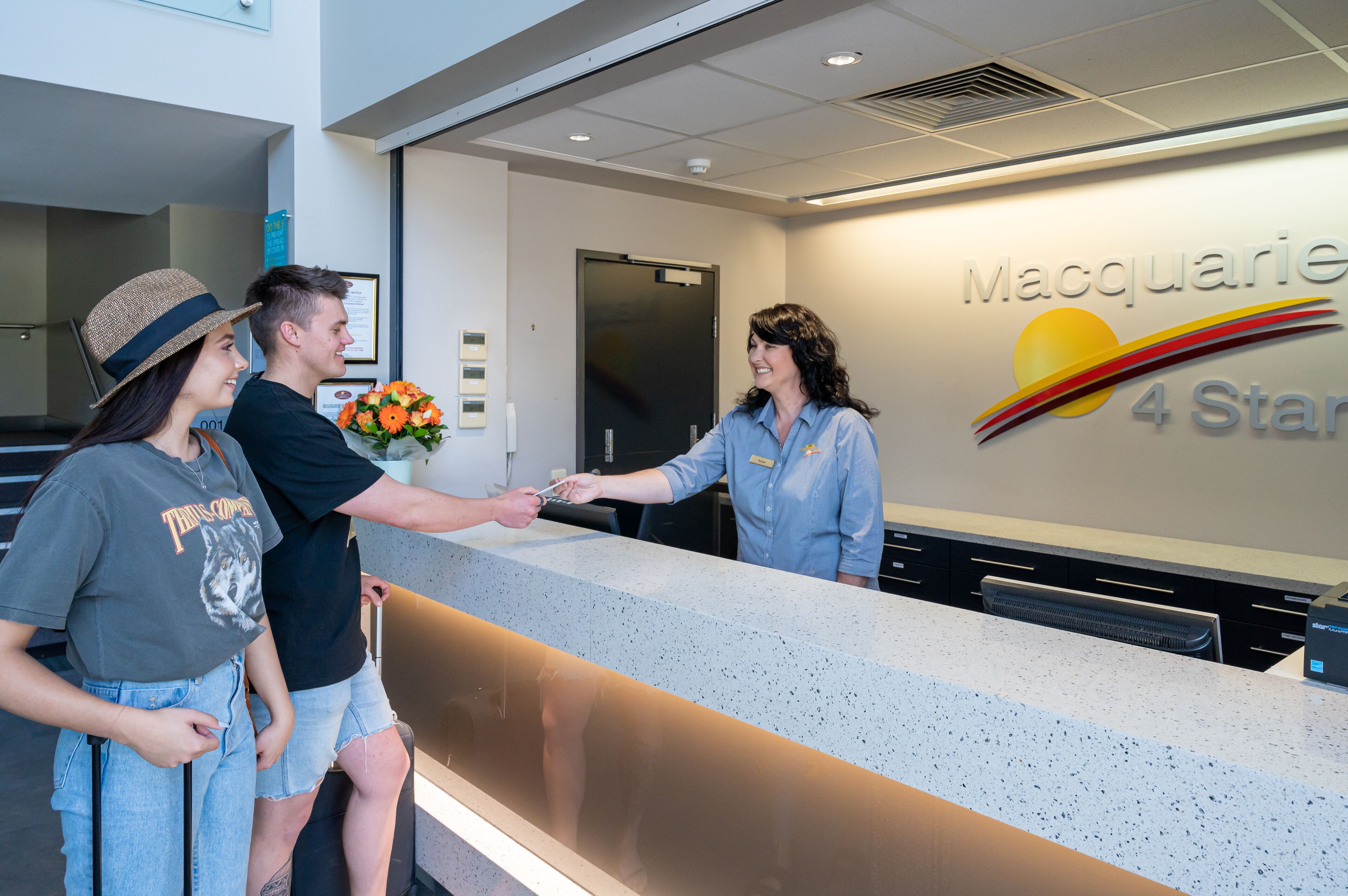 A reception desk with a sign reading "Macquarie 4 Star".