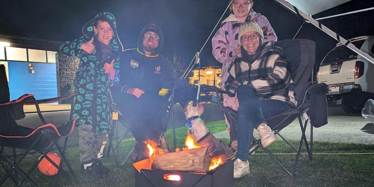 A group of people around a campfire at night.