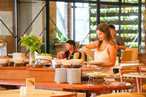 A buffet setup with various dishes and a serving counter. - Crystal Jade Hotel (Rayong)