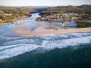 An aerial view of a coastal area with a bridge, sandy beach, and a river. - Pelican Sands Scamander (Scamander)