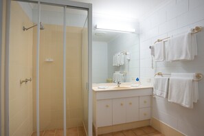 Shower, hair dryer, towels, shampoo