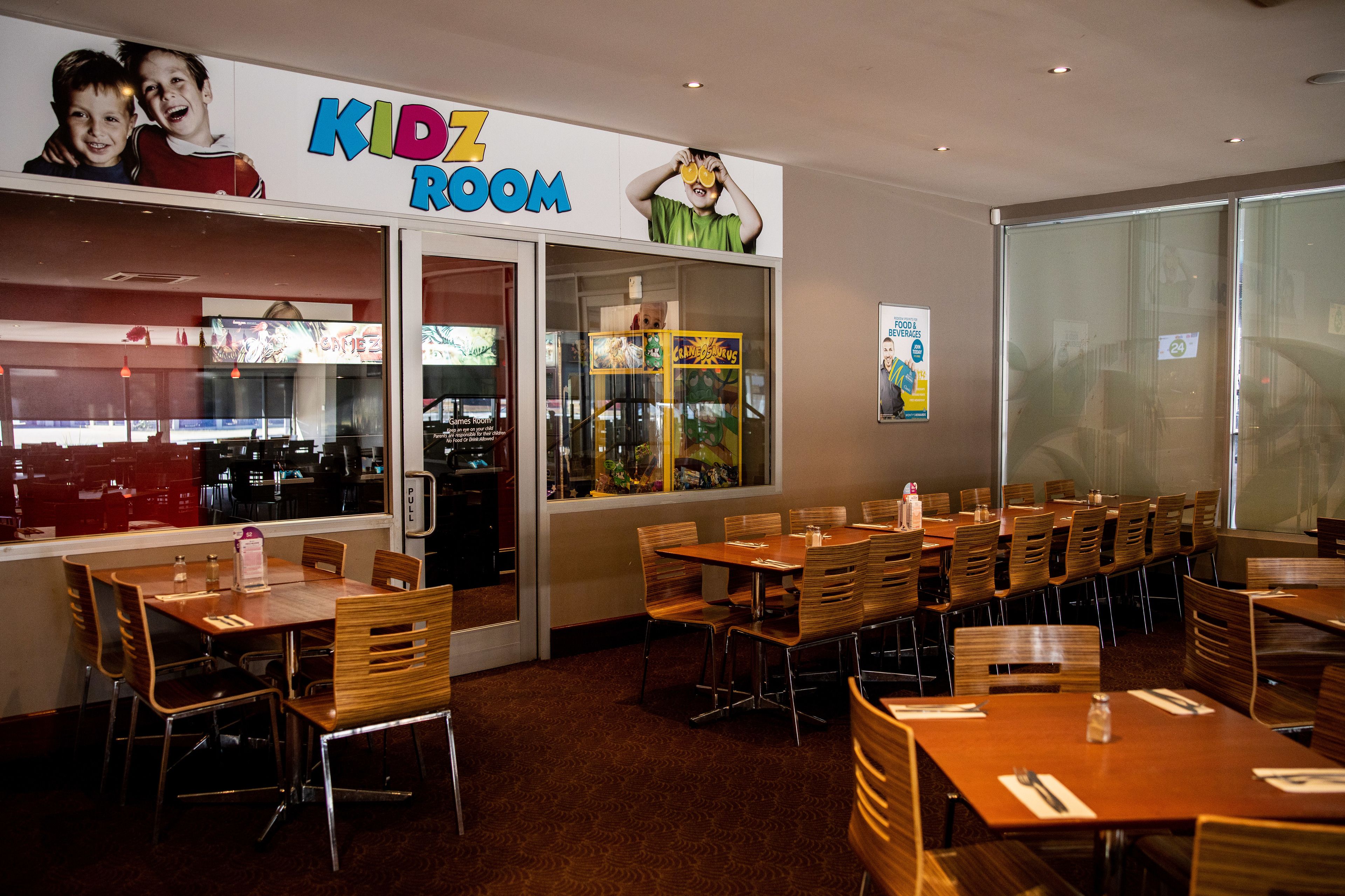 A Kidz Room with tables and chairs, a play area, and a view of the city.