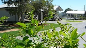 A residential area with houses, a paved driveway, and green lawns. - Barcaldine Country Motor Inn (Barcaldine)