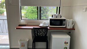 A compact kitchenette with a microwave, coffee maker, and a small refrigerator. - Hi-Way Motel Grafton - Digital & Contactless (South Grafton)
