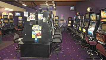 A row of slot machines in a casino with purple walls and a star-patterned carpet.