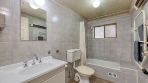 A bathroom with a sink, toilet, and bathtub.