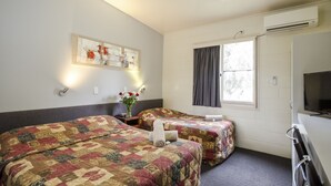 A hotel room with two beds, a TV, an air conditioner, a window with curtains, and a painting on the wall. - Biloela Countryman Motel (Biloela)