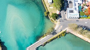 An aerial view of a coastal area with a road leading to a building labeled "BRUNSWICK RIVER INN".