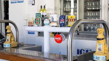 A bar area with various beer taps and a Coca-Cola classic tap.