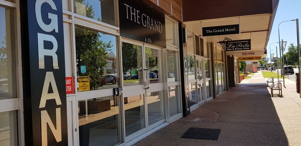 A hotel entrance with a sign for 'The Grand' and 'The Grand Motel'. - The Grand Motel (Griffith)