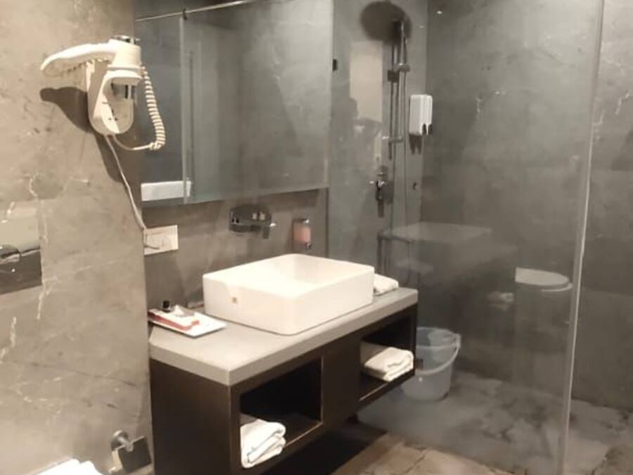 A modern bathroom with a shower, toilet, and vanity.