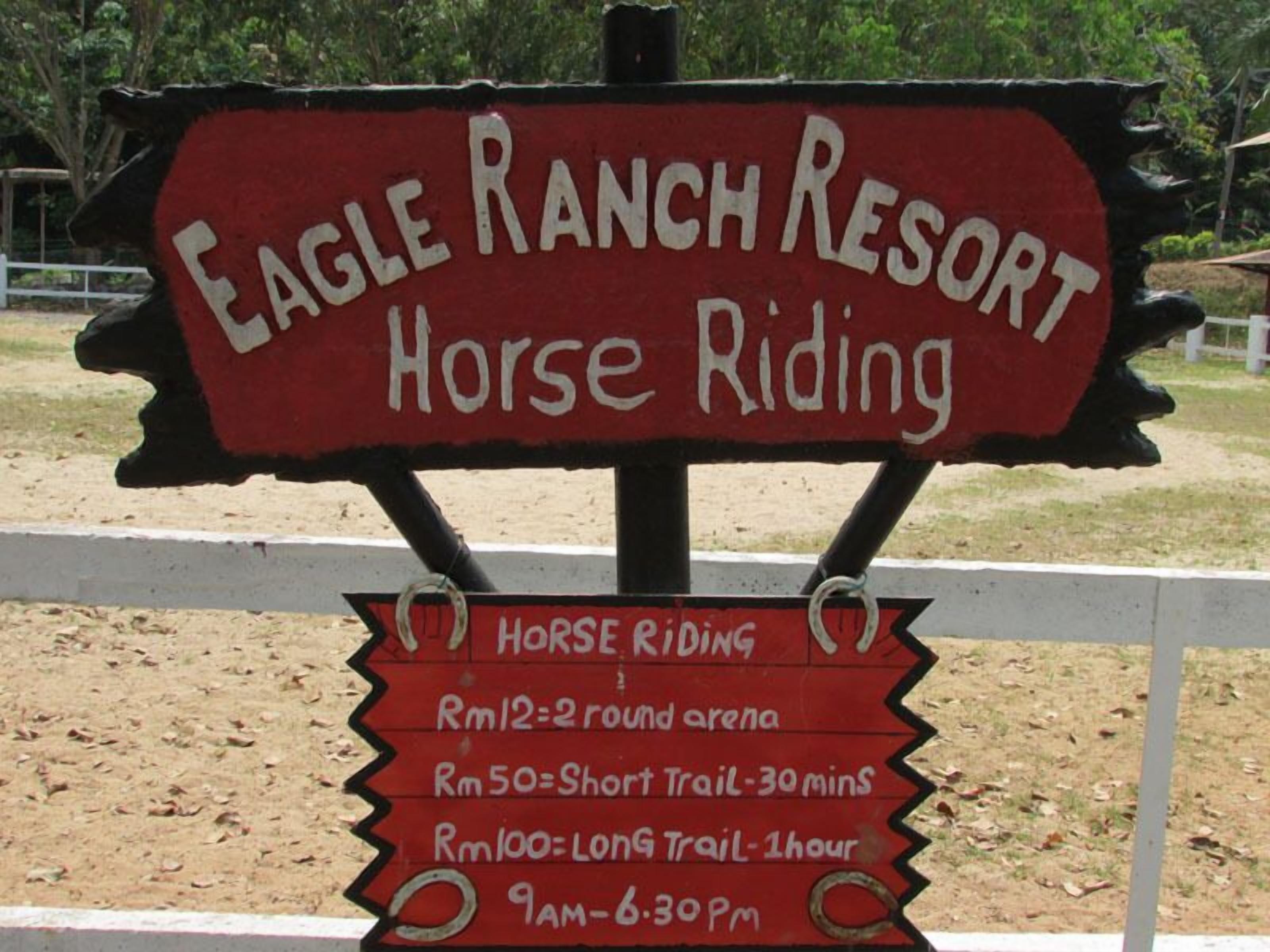 A sign for Eagle Ranch Resort Horse Riding with pricing and hours of operation.