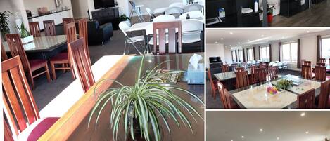 A hotel lobby with a dining area, a TV, and a fish tank.