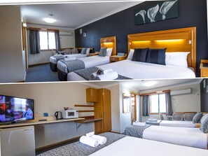 A hotel room with two beds, a TV, a microwave, and a small kitchenette.