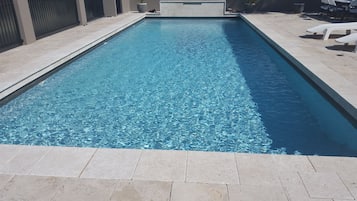 Seasonal outdoor pool, open 9:00 AM to 9 PM, pool loungers