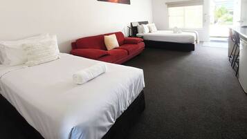 Deluxe Room, Non Smoking (Deluxe Queen and Single) | Desk, laptop workspace, iron/ironing board, free WiFi
