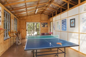 A ping pong table in a wooden room with framed marine life pictures on the walls. - Mandala Bruny Island (Alonnah)