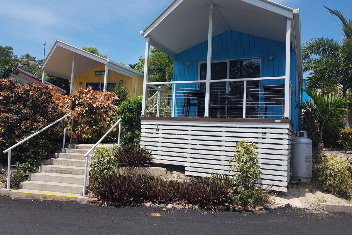 A two-story building with a blue upper level and a yellow lower level.